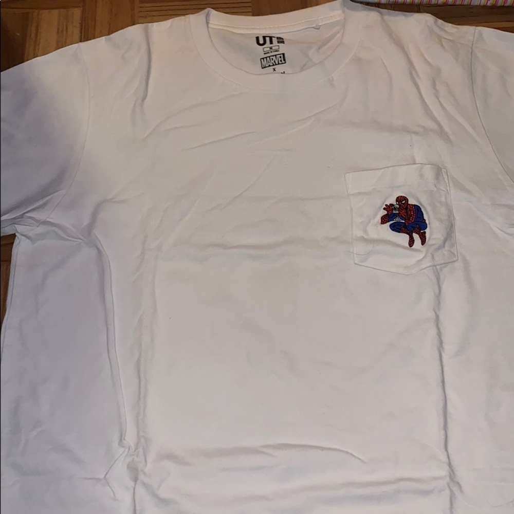 White shirt with Spider-Man drinking coffee